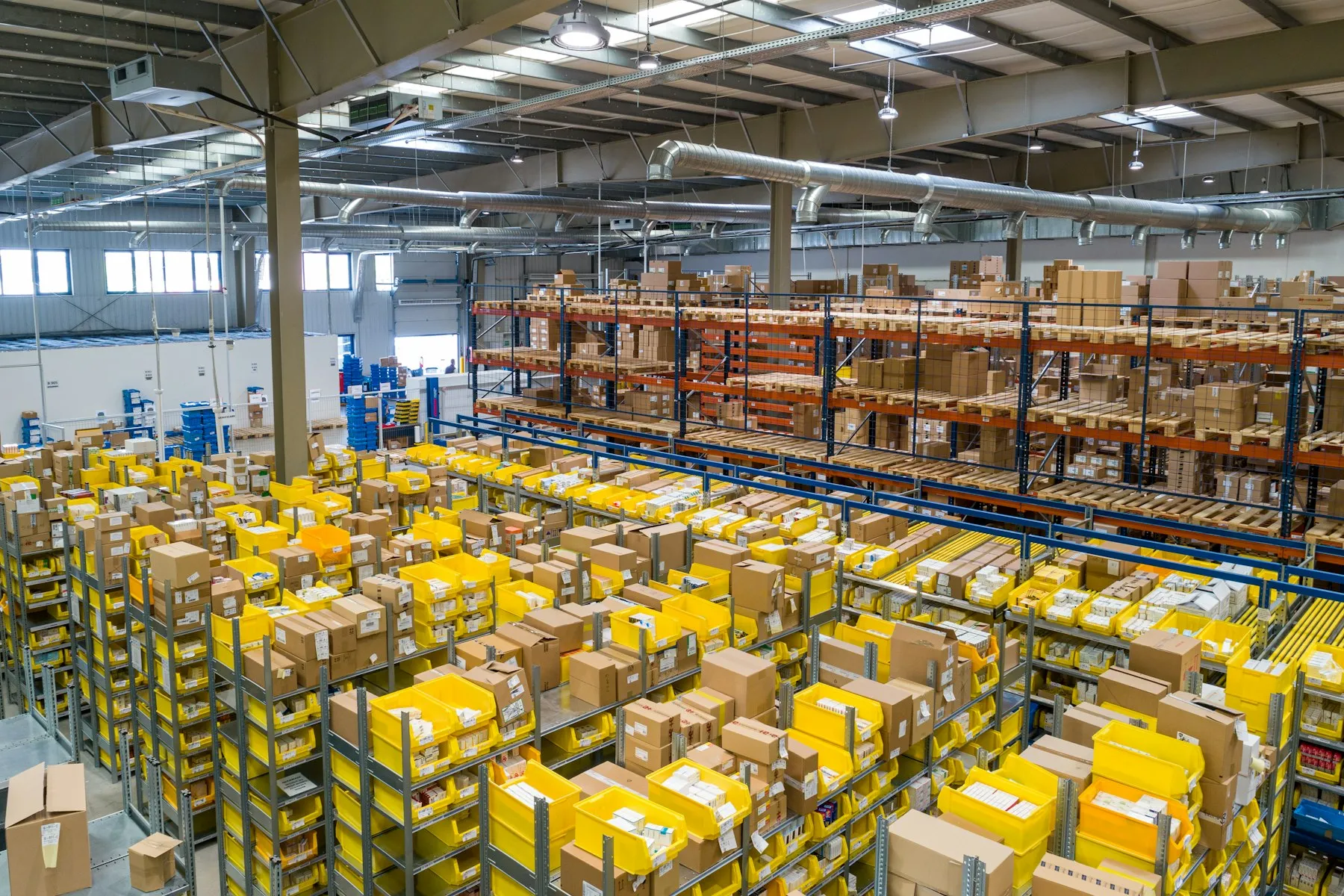 Distribution center floor with organized picking bins and pallet racking
