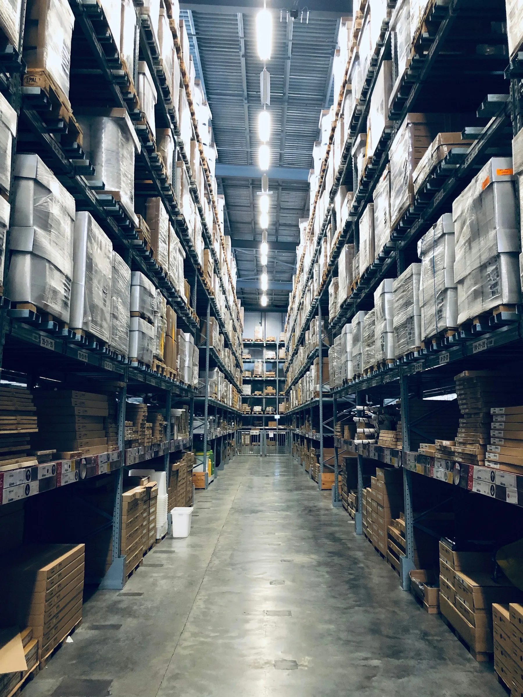 High-bay warehouse racking stocked with palletized goods